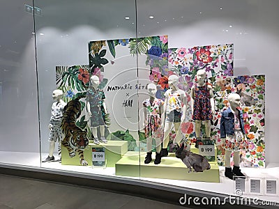 H&M clothed mannequins with children fashion clothing and red in the glass-window display in Blueport shopping mall Hua Hin, Editorial Stock Photo