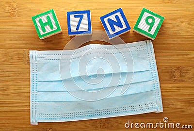 H7N9 alphabet block with face mask Stock Photo