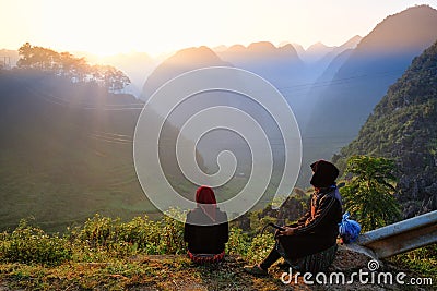 Ha Giang / Vietnam - 01/11/2017: Two local Vietnamese women in traditional clothes looking at the sunrise and mountain scenery in Editorial Stock Photo