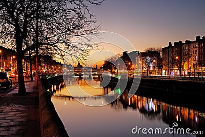 Ha`penny Bridge and the north banks of the river Liffey in Dublin City Centre at night Editorial Stock Photo