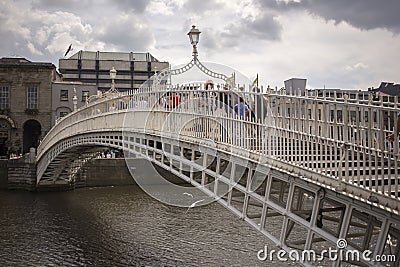 Ha`penny Bridge over Liffey river in Dublin, Ireland Editorial Stock Photo