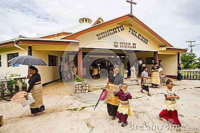 Polynesian parishioners in traditional Tongan dress walk out of church as Catholic Mass ends, Haapai, Tonga, Polynesia. Editorial Stock Photo