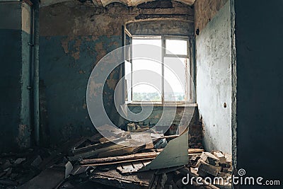 Habitation of homeless man inside in abandoned house. Peeling walls Stock Photo