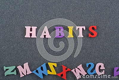 HABITS word on black board background composed from colorful abc alphabet block wooden letters, copy space for ad text. Learning Stock Photo