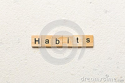 HABITS word written on wood block. HABITS text on cement table for your desing, concept Stock Photo