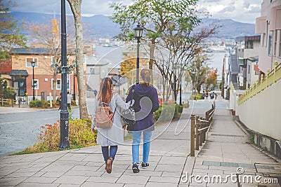 Two beautiful woman walking on the street in Hachiman-zaka slop, Japan Editorial Stock Photo