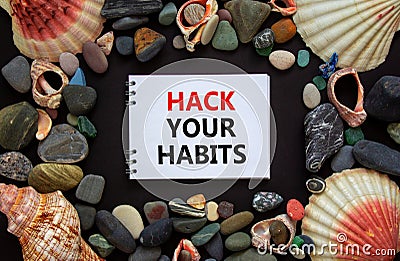 Hack your habits symbol. Words `Hack your habits` on white note, black background. Sea stones and seashells. Business, psycholog Stock Photo
