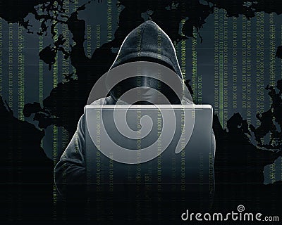 Hacker in black hoodie holding laptop with his hand and world map with binary code Stock Photo