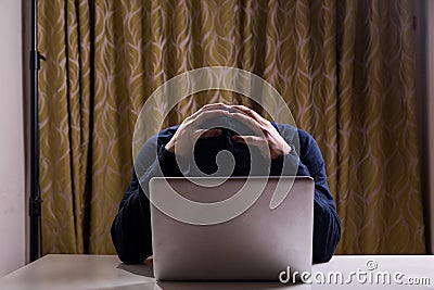 Hacker with both hands on head after failed attempt Stock Photo