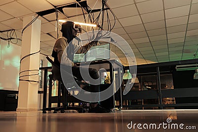 Hacker breaking into computer system in vr, hacking database Stock Photo