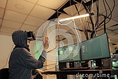Hacker coding script in vr headset Stock Photo