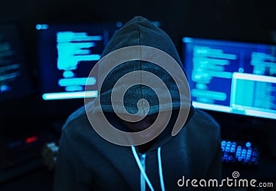 Hacker with computer background and hoody Stock Photo