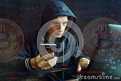 Hacker with a face is trying to steal cryptocurrency using a computer. Fraud at Cryptojacking Stock Photo