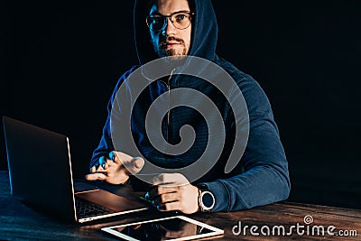 Hacker finding and exploiting the weakness in computer systems to gain access. Stock Photo