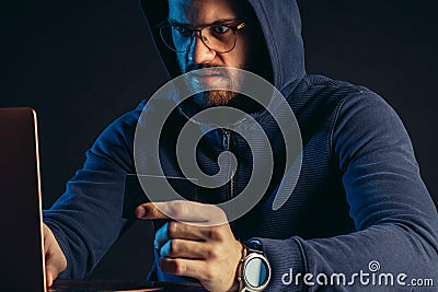 Hacker finding and exploiting the weakness in computer systems to gain access. Stock Photo