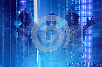 Hacker groups in black hoodie standing with binary code on virtual screen Stock Photo