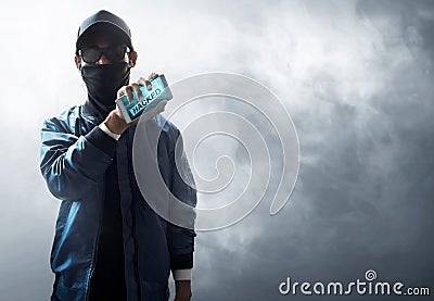 Hacker holding mobile phone Stock Photo