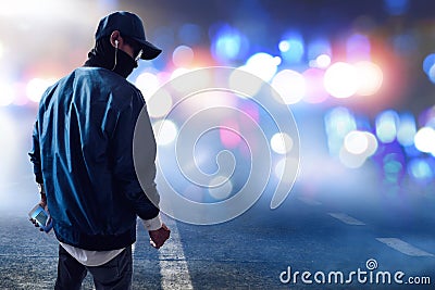 Hacker holding mobile phone on the street Stock Photo