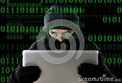 Hacker man in black using computer laptop for criminal activity hacking password and private information Stock Photo