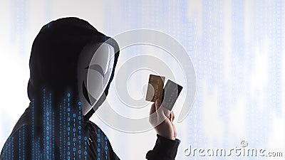 Credit cards personal data stolen by anonymous man in Black hood shirt Stock Photo