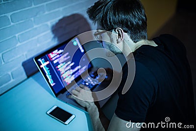 Hacker man trying to breach security of a computer system search internet Stock Photo