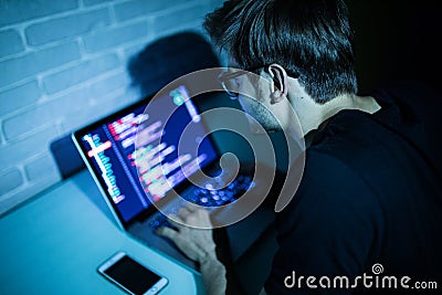 Hacker man trying to breach security of a computer system search internet Stock Photo