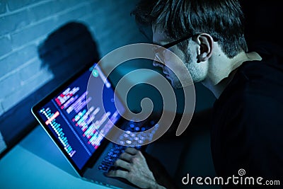 Hacker man trying to breach security of a computer system search internet Stock Photo