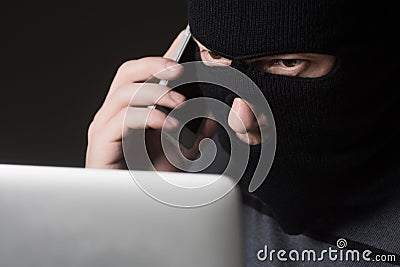 Hacker in a mask Stock Photo