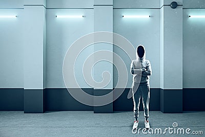 Hacker standing in abstract illuminated concrete interior Stock Photo