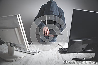 Hacker stealing information from the office computer. Hacking, Criminal Stock Photo