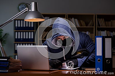 The hacker stealing personal data from home computer Stock Photo