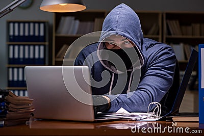 The hacker stealing personal data from home computer Stock Photo