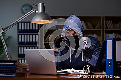 The hacker stealing personal data from home computer Stock Photo