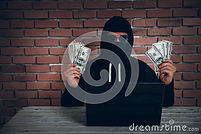 Hacker try to hack and steal information system data from computer and show money after hacked it Stock Photo