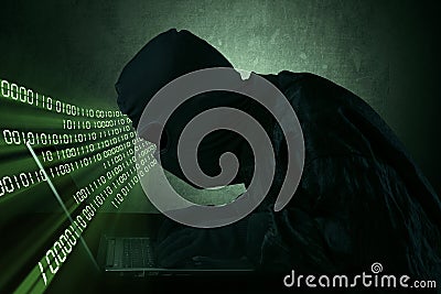 Hacker typing on a laptop Stock Photo