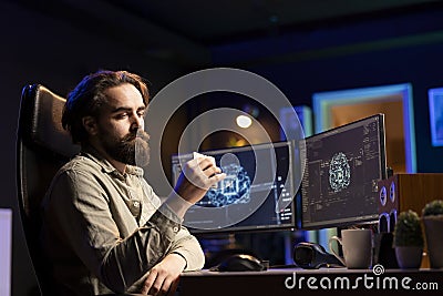Hacker uploading evolved sentient AI to disk, planning to use it for evil plan Stock Photo
