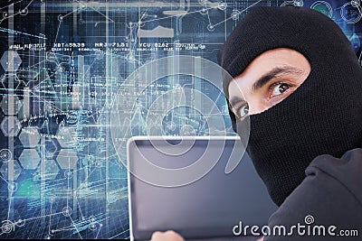 Hacker using his computer with cover face Stock Photo