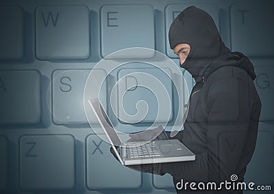 Hacker using a laptop in front of digital background of keyboard Stock Photo