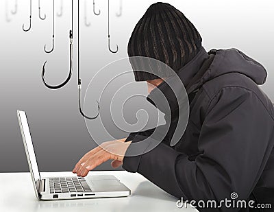 Hacker working with a laptop computer and hooks Stock Photo