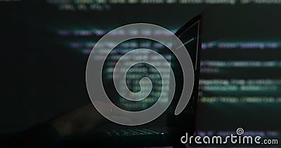 Hacker writing code cracking computer. Programming code in the background. Hacker attack, cybercrime, virus software Stock Photo
