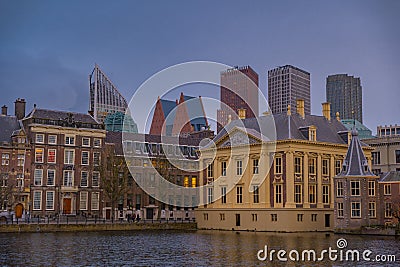 Binnenhof castle (Dutch Parliament) with the Hofvijver lake against a background of skyscrapers Editorial Stock Photo