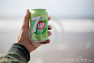 The Hague, Netherlands - 09.06.2019: Young man holding a bank of new 7up free. Editorial Stock Photo