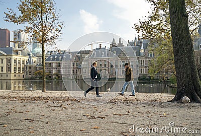 The Hague, November 10, The Hague, The Netherlands. Two men pass each other at a distance of 1.5 meters. Courtyard and seagulls in Editorial Stock Photo