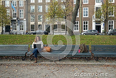 The Hague, November 10 The Hague, The Netherlands Work at home, stay at home and keep your distance. Young woman in casual clothes Editorial Stock Photo