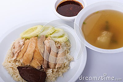 Hainanese chicken rice, steamed chicken, chicken blood and white rice on brown cloth background. Stock Photo