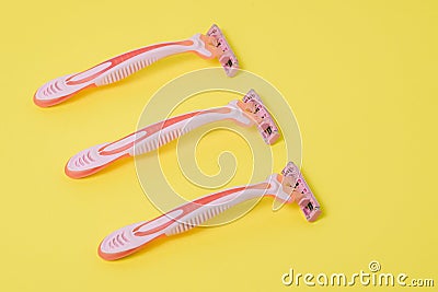 Hair depilation. Pink razors on a colored background. Hair removal from the face and legs. Women`s hygiene Stock Photo