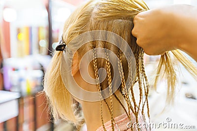 Hair dresser making dreadlocks Stock Photo