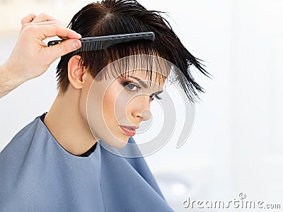 Hair. Hairdresser doing Hairstyle. Beauty Model Woman. Haircut. Stock Photo