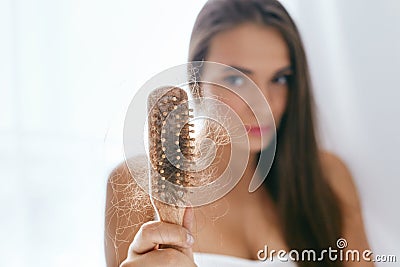 Hair Loss. Upset Woman Holding Brush With Hair Stock Photo
