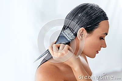 Hair Mask. Woman Applying Conditioner On Long Hair With Brush, Hair Care Treatment Stock Photo